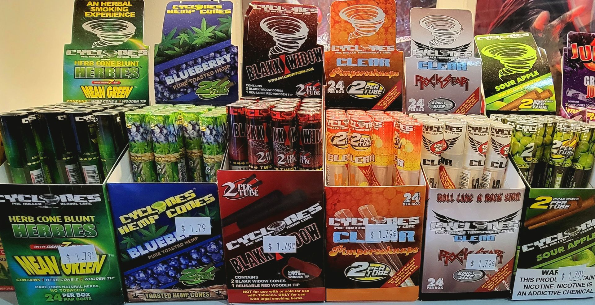 Display of various flavored rolling papers in colorful packaging.