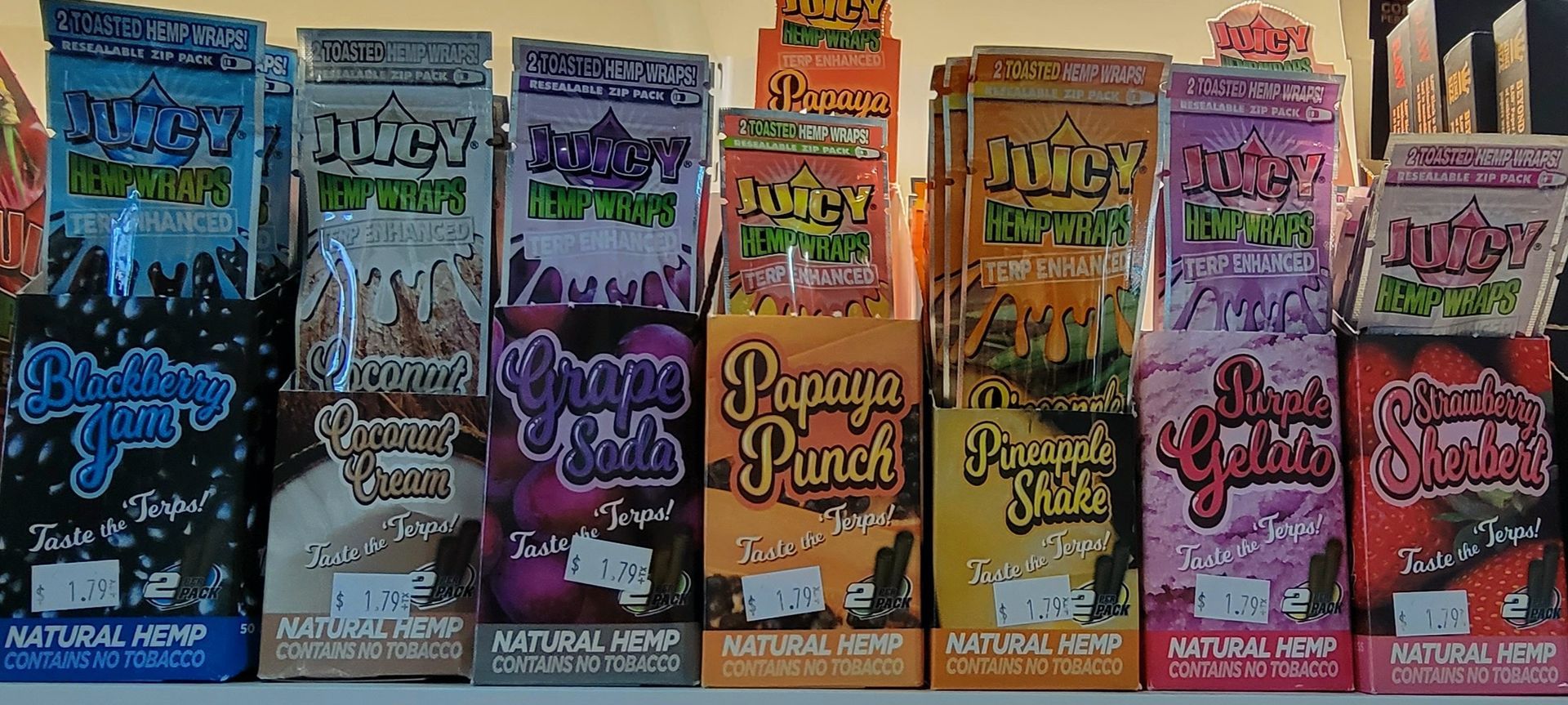 Shelf with colorful packages of flavored blunt wraps.
