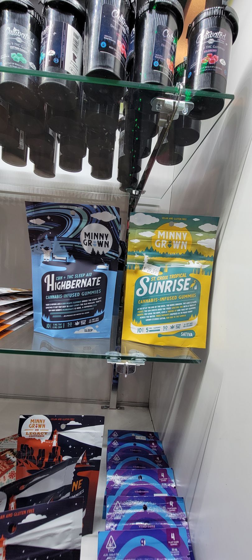 Shelves display jars, two bags labeled 