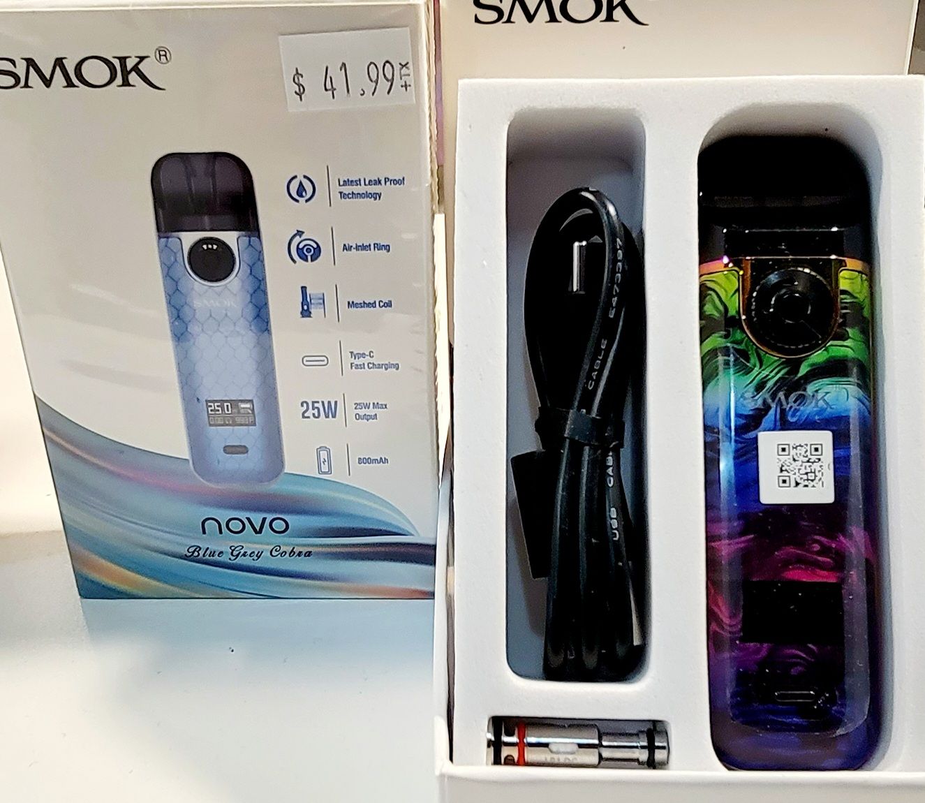 Two vape devices with boxes; one blue, one colorful. Both labeled 