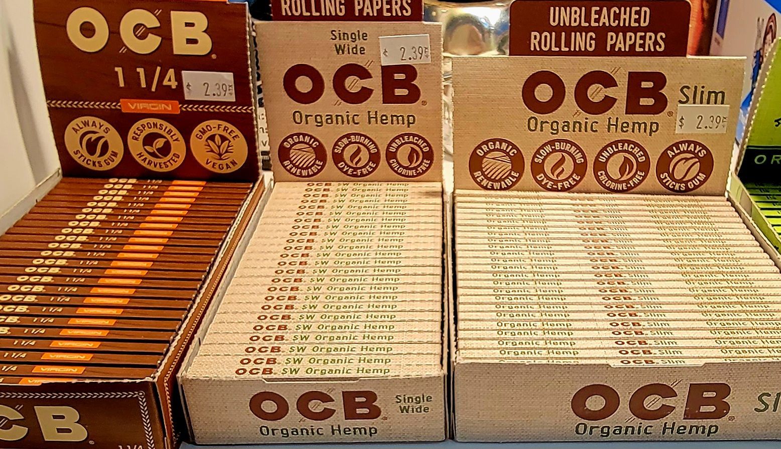 Display of OCB rolling papers, various sizes, brown packaging.