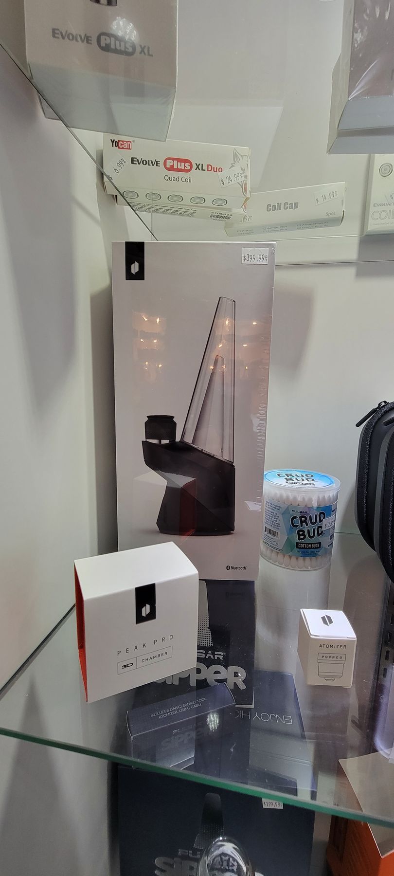 A display case with a large box showing a product, plus other small boxes and items.