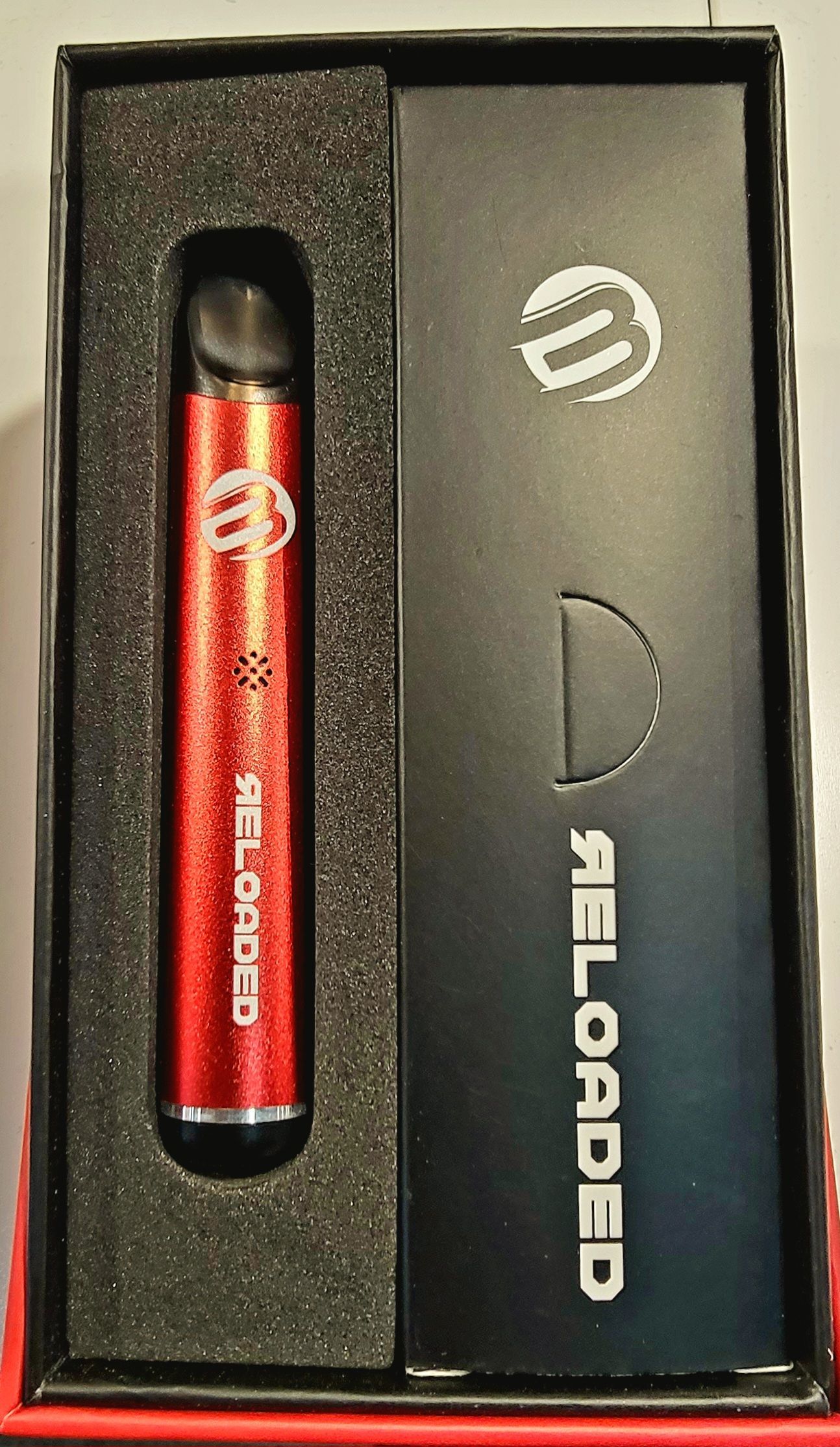 Red and black vape pen in a box labeled 