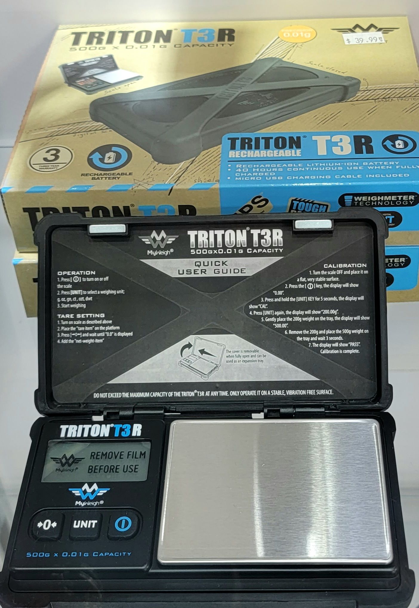 Digital scale, black, displayed open. Box behind reads 