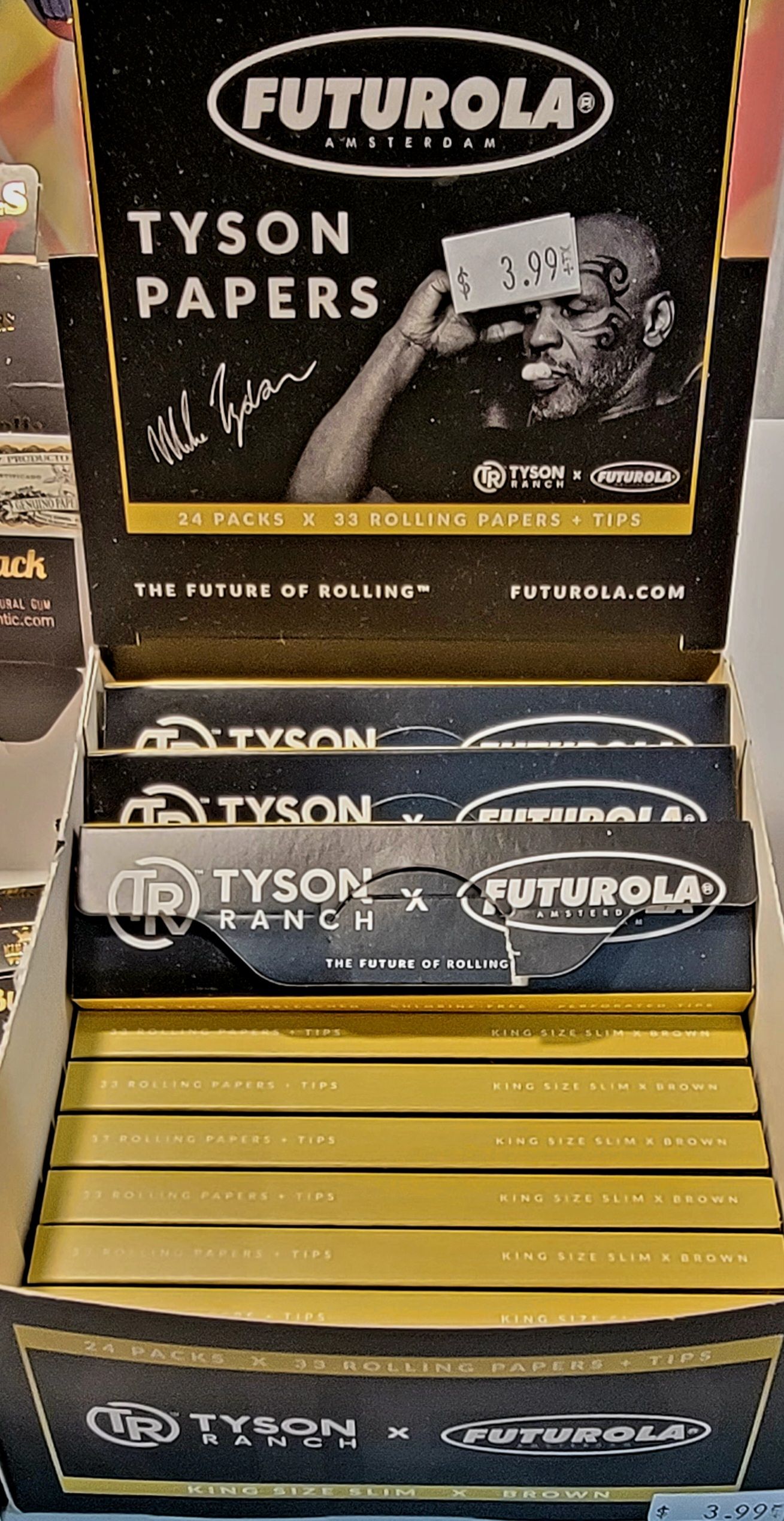 Display case of Futurola Tyson rolling papers, featuring Mike Tyson's signature and image on packaging.