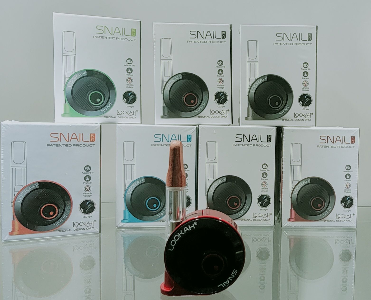 Boxes of Snail vape pens in various colors: red, green, blue, and black, displayed on a reflective surface.