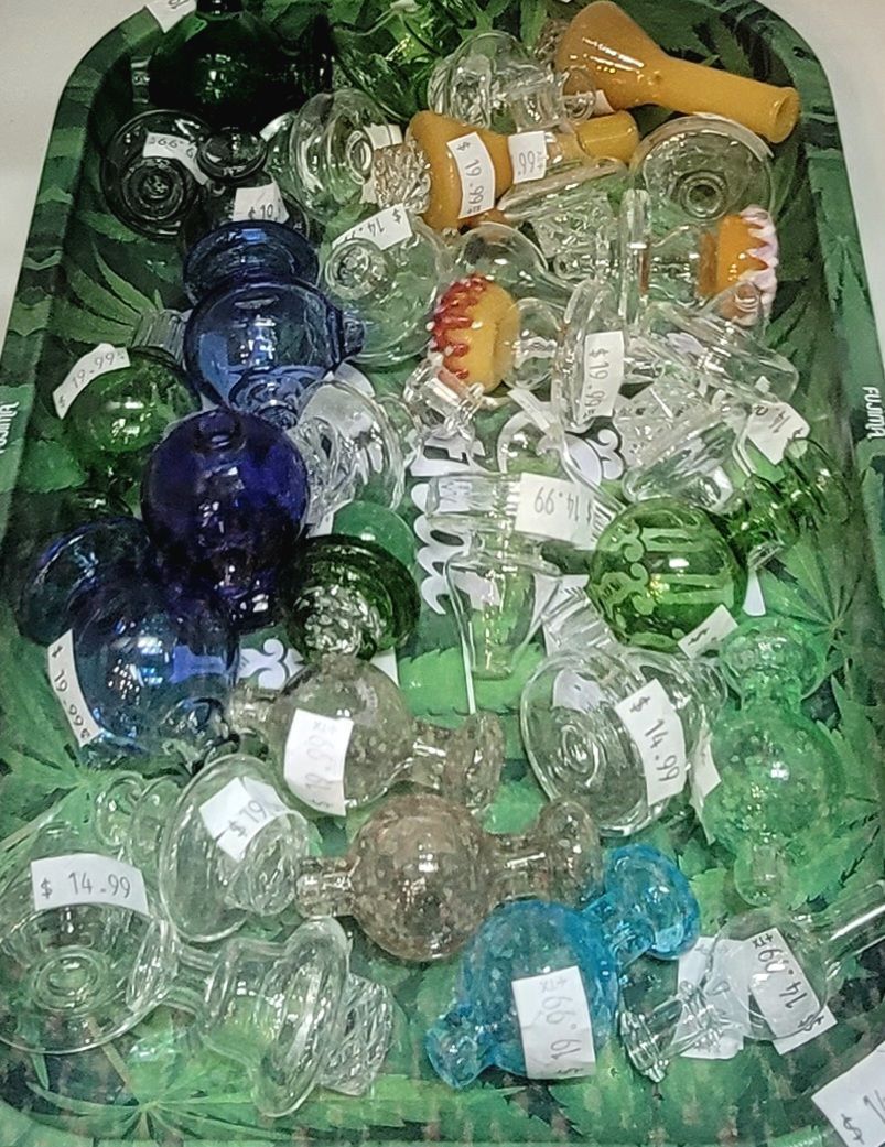 Glass ornaments in a green bin, various colors and styles, some with price tags.