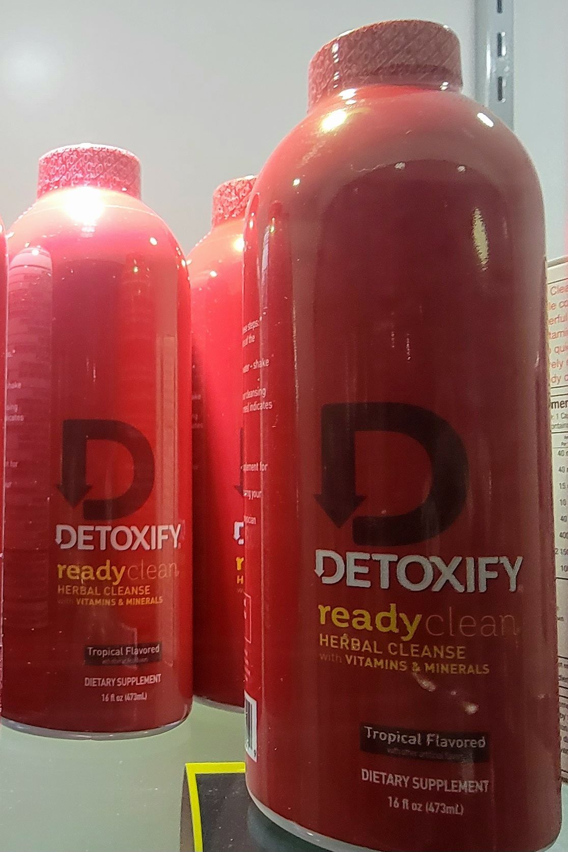 Red bottles of Detoxify readyclean herbal cleanse. Tropical flavored, dietary supplement.