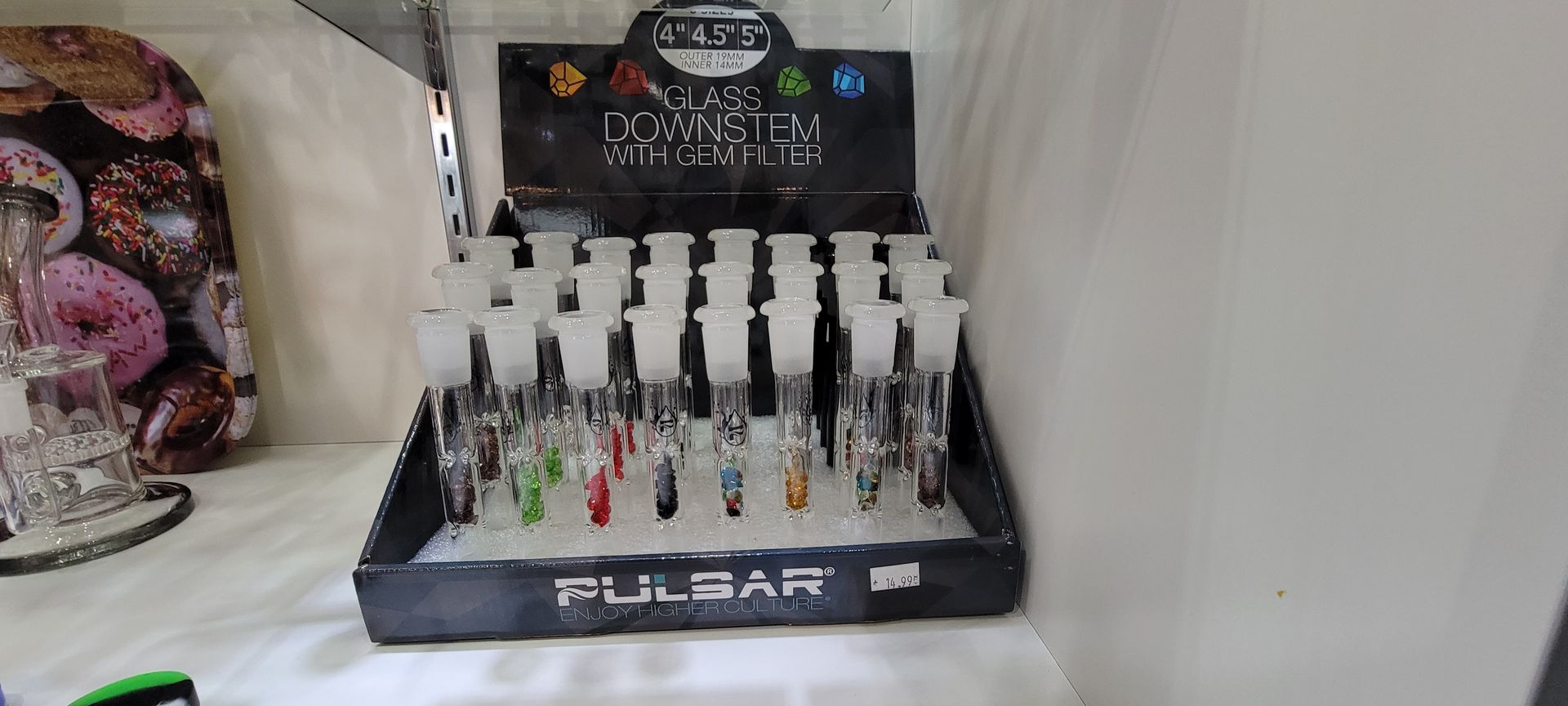 A display case with various glass pipes labeled 