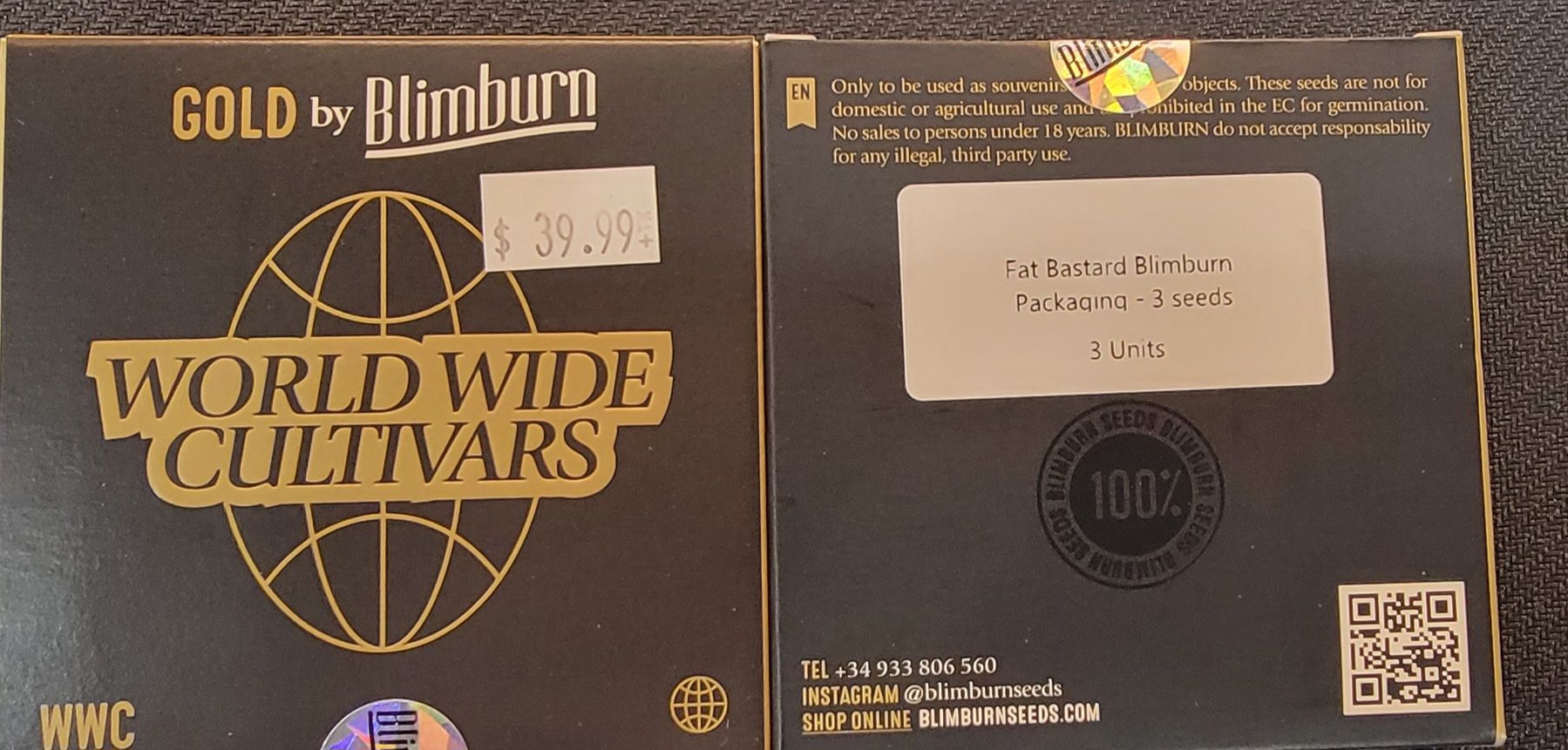 Two black boxes side-by-side with gold text. Front box has 