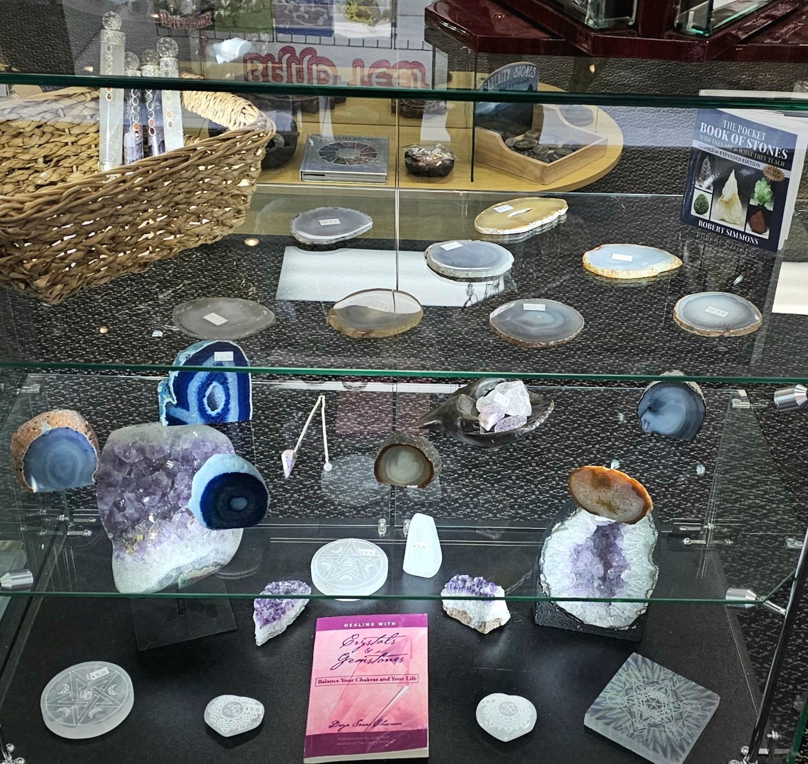A display case with various polished gemstones and crystals.