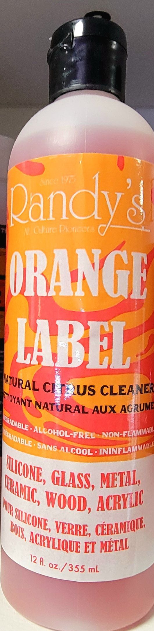 Orange Label cleaner bottle with black cap. Orange label with white text. Cleans metal, vinyl, acrylic.