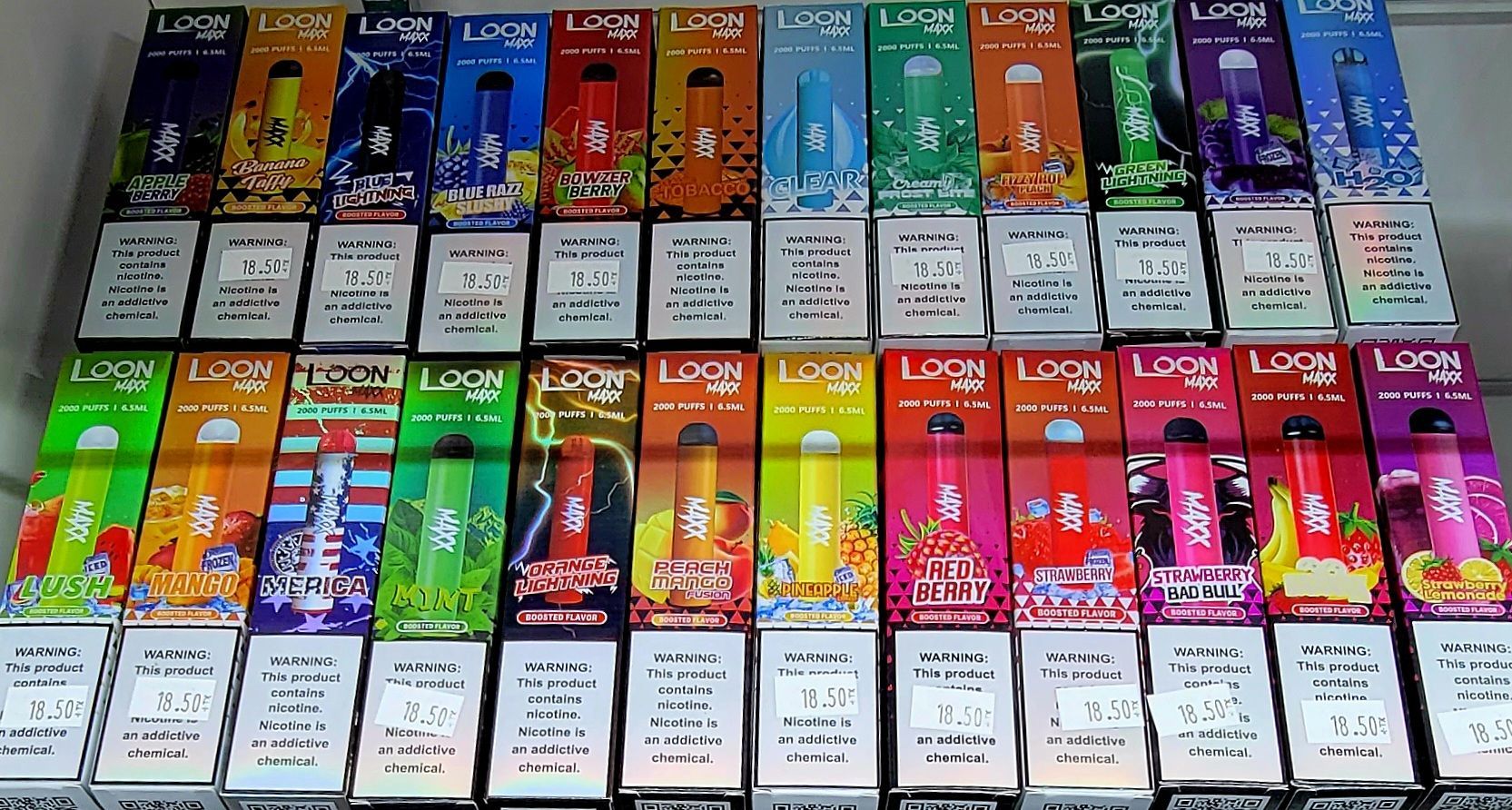Rows of colorful disposable vapes with various flavors.