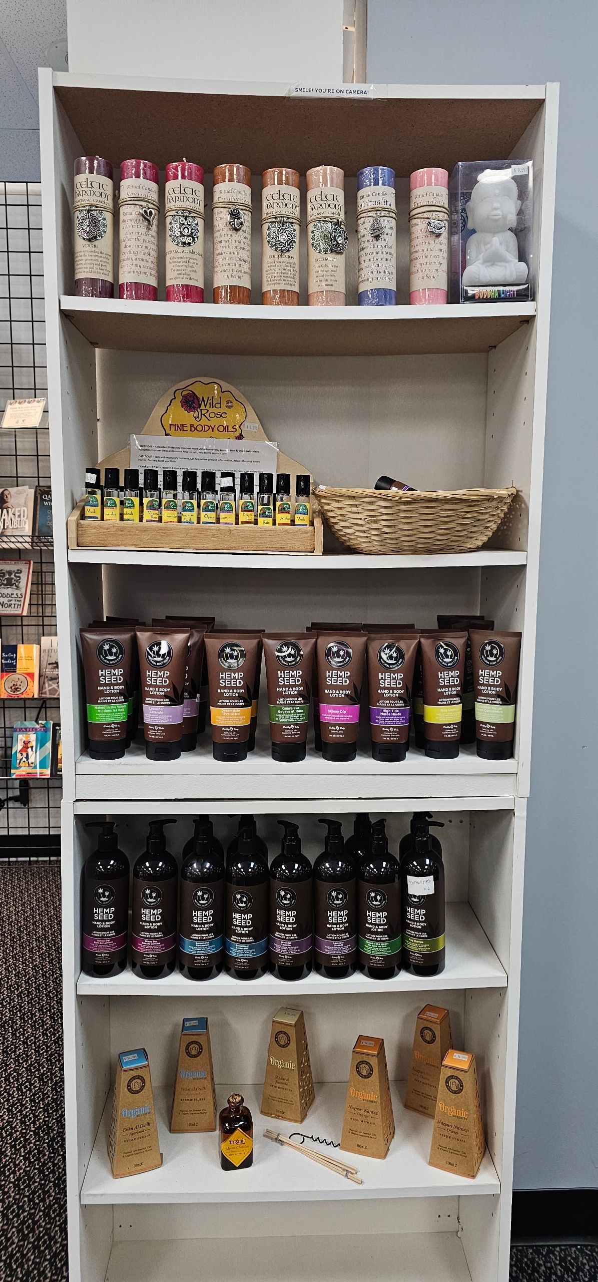 White shelves displaying various cosmetic products in a store setting.