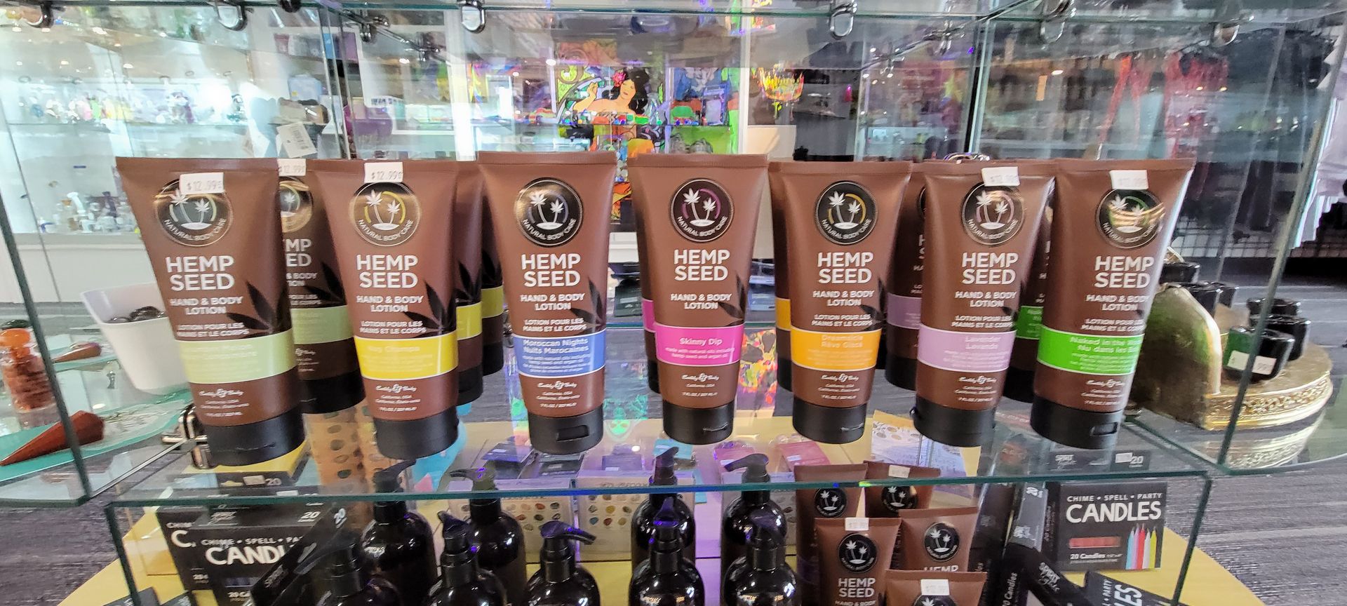 Shelf with brown tubes of Hemp Seed lotion, in a store setting.