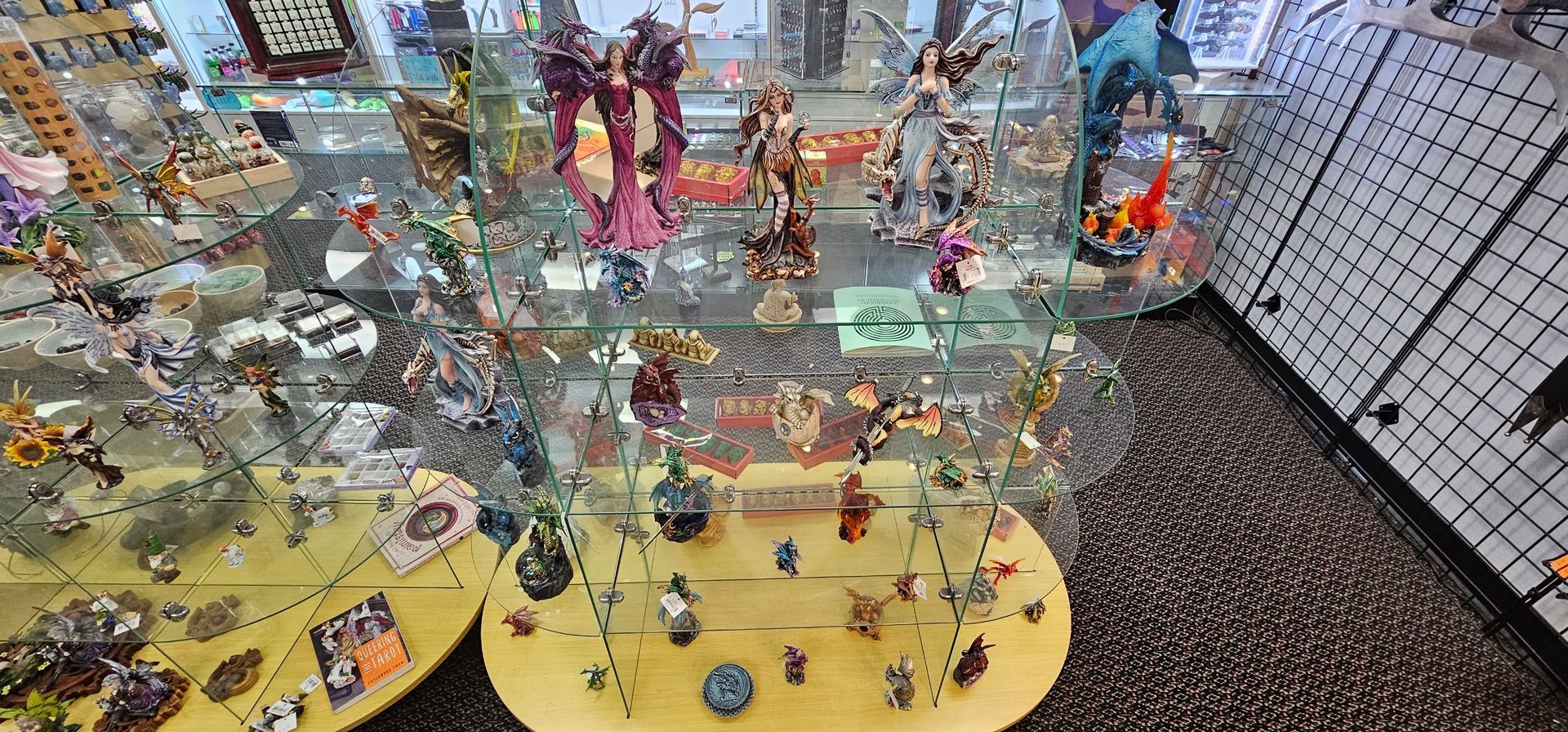 Inside a store, a glass display case is filled with figurines.