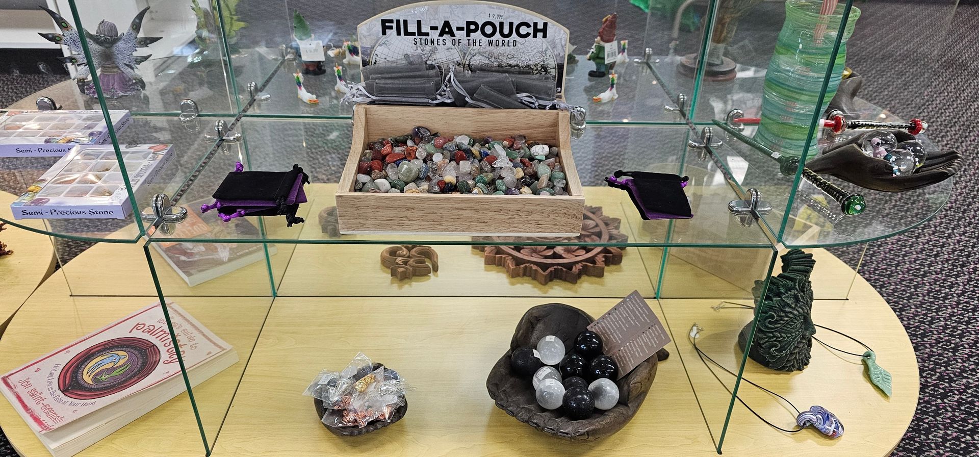 Display case with crystals, necklaces, and a 