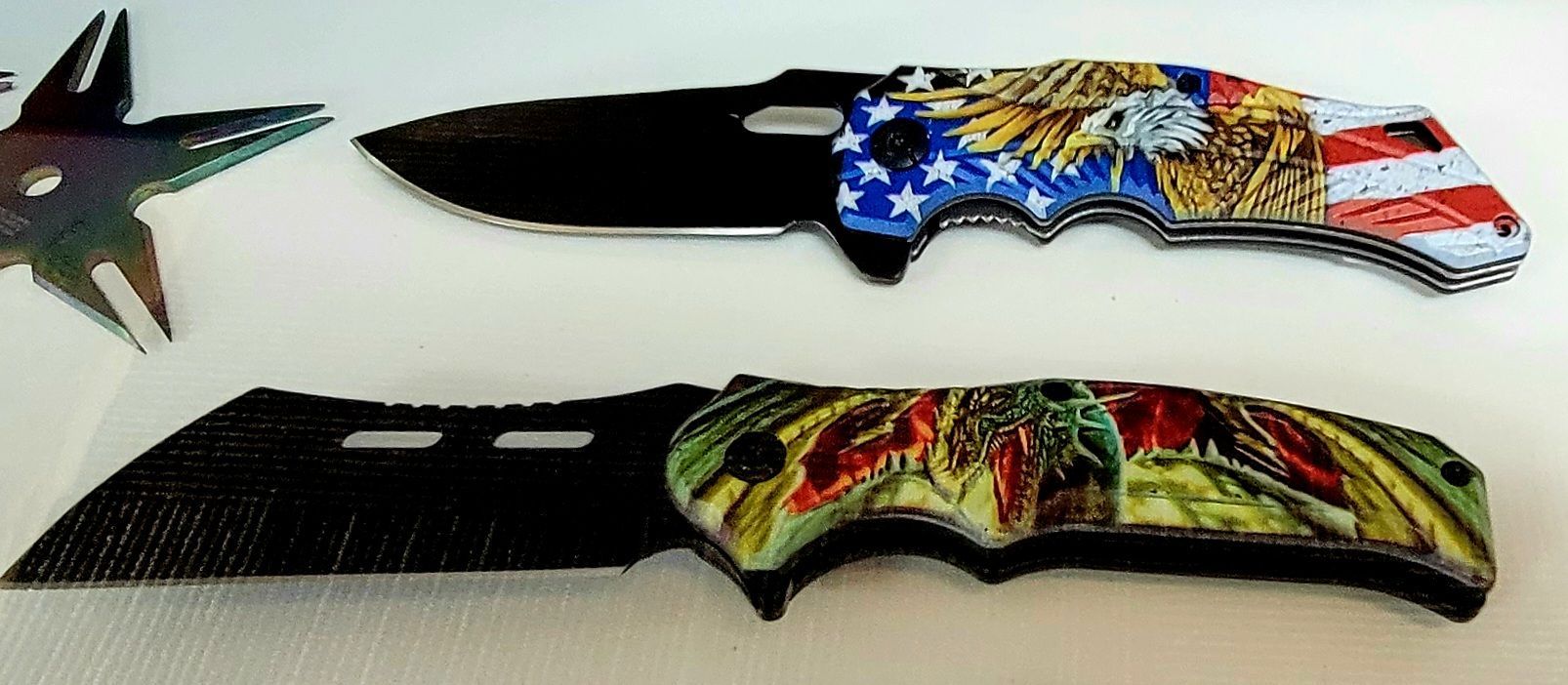 Two decorative knives: one with American flag design and an eagle; the other with a floral pattern.