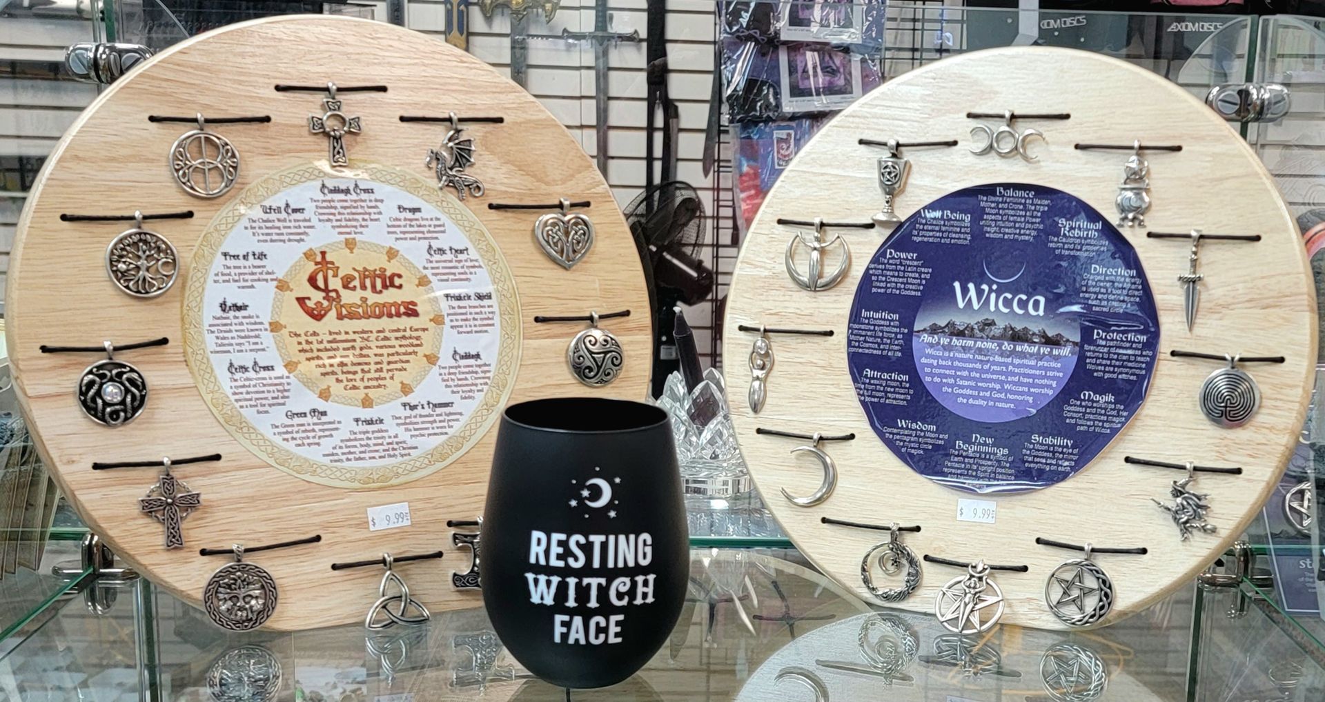 Two circular wooden charm displays with Wiccan and Celtic symbols, 