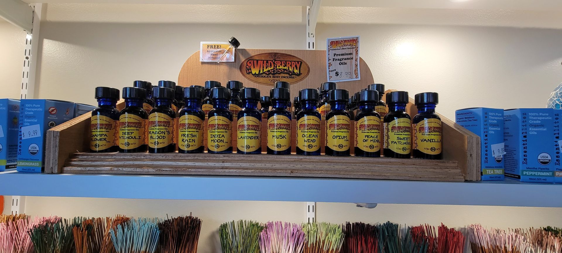 Bottles with yellow labels on a store shelf, blue caps.  Additional products are on shelves below.