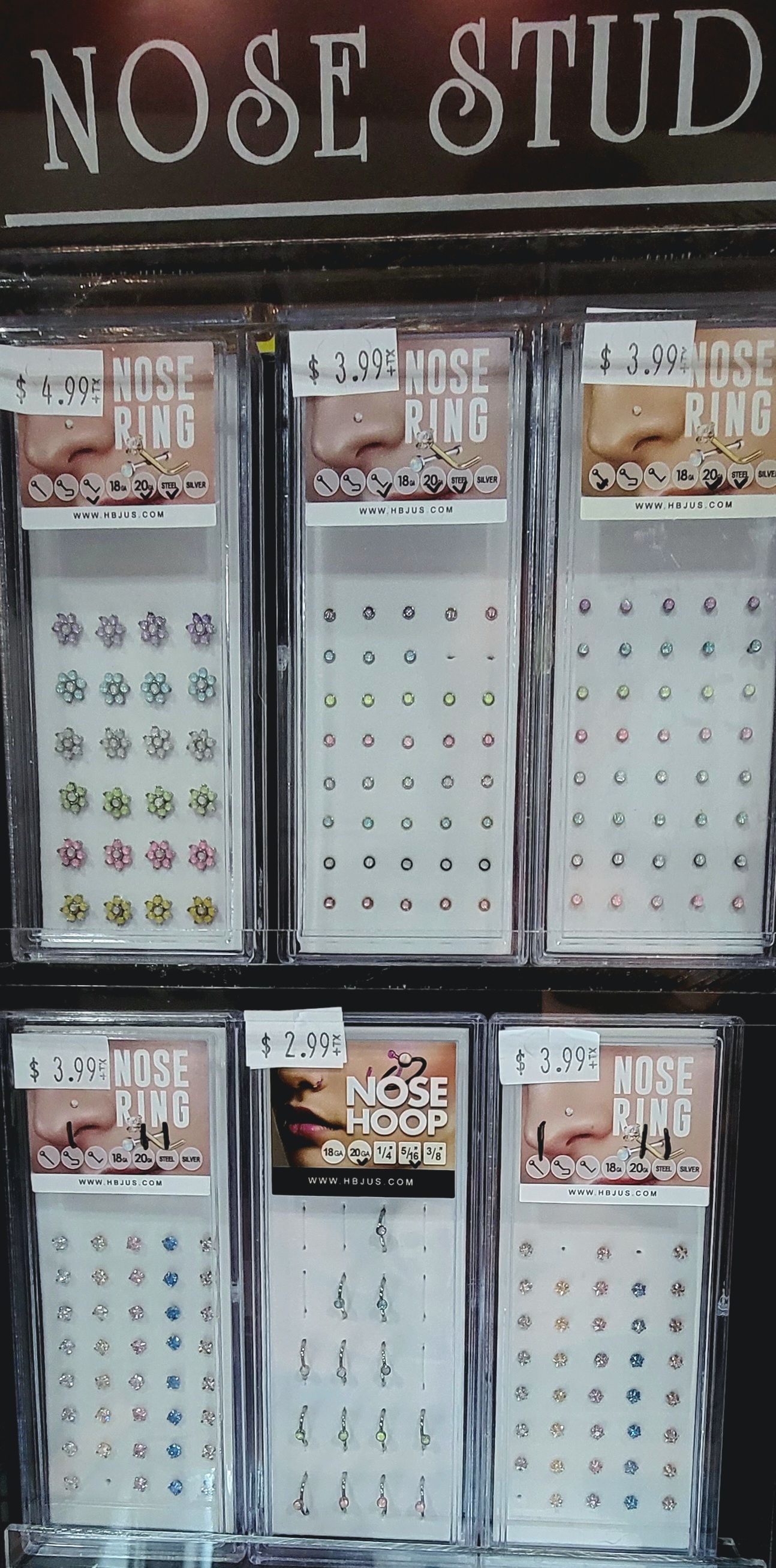 Nose stud display with various styles, colors and prices.