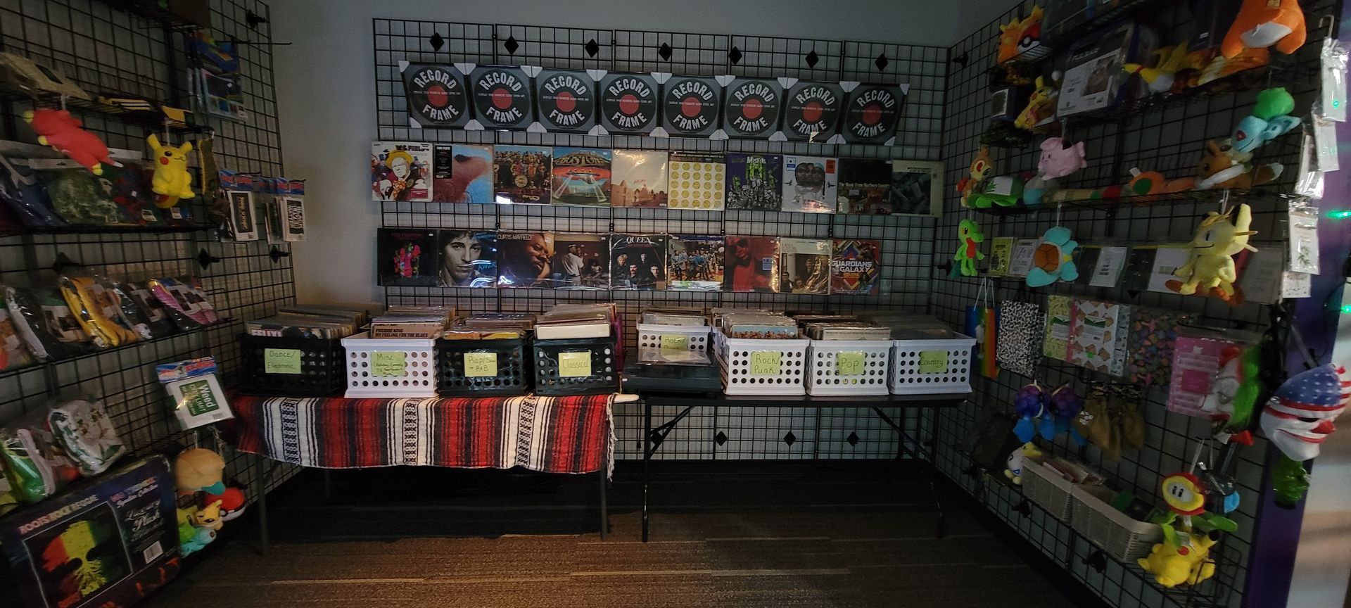 A store interior displaying merchandise, including cards, toys, and games, with shelves and a table.