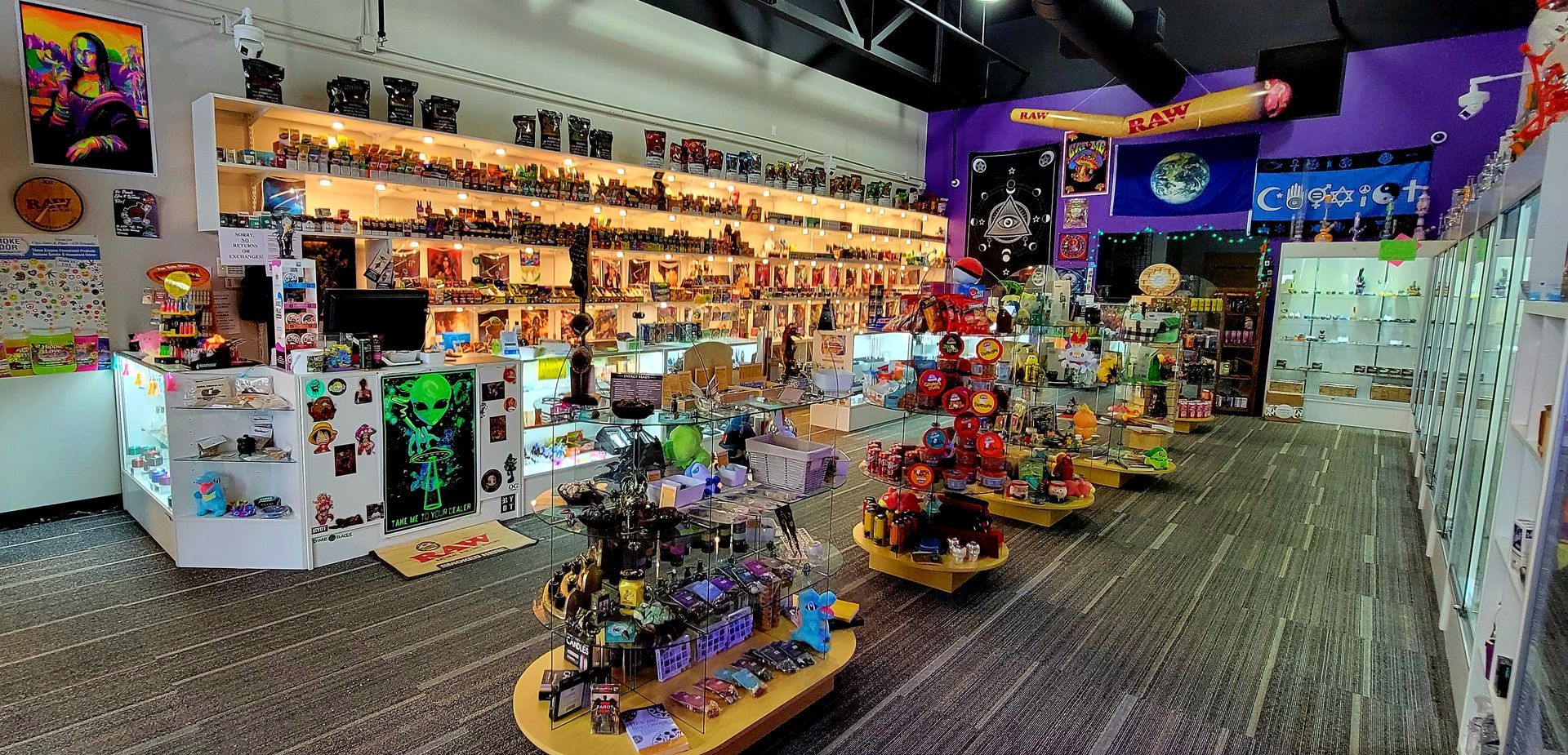 Inside of a brightly lit store with many shelves of items. There are action figures, figurines, and collectibles.