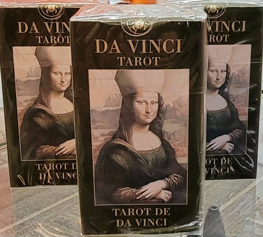 Three Da Vinci Tarot decks, featuring the Mona Lisa on the black boxes.