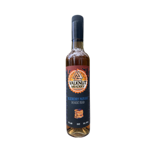 Bottle of Valknut Meadery Blueberry mead with a black cap and label.