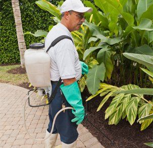 Pest Control Technician Using Spray Nozzle And Hose — Pest in Lecanto, FL