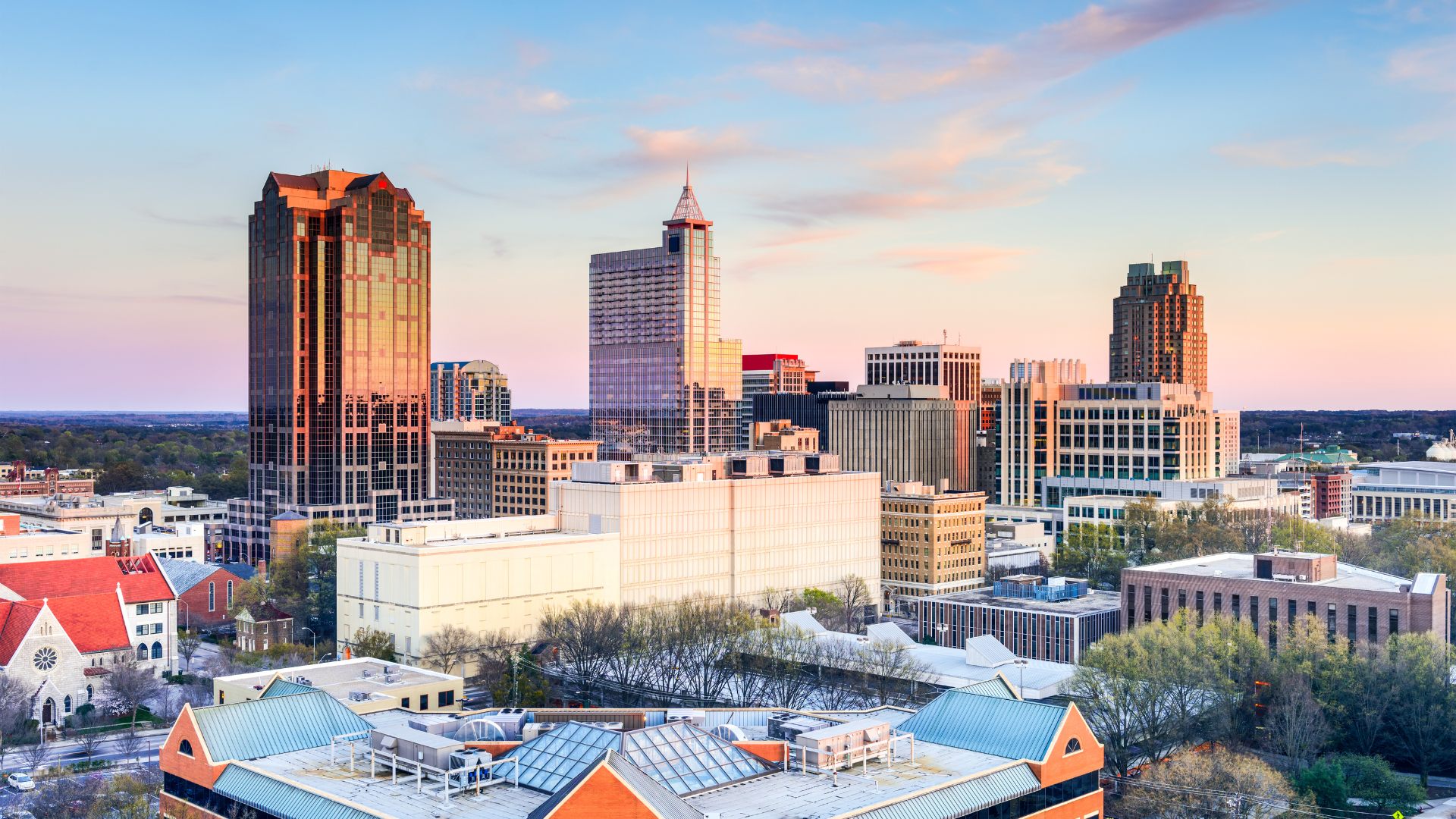 A living room with a couch , chairs , coffee table , fireplace and television.