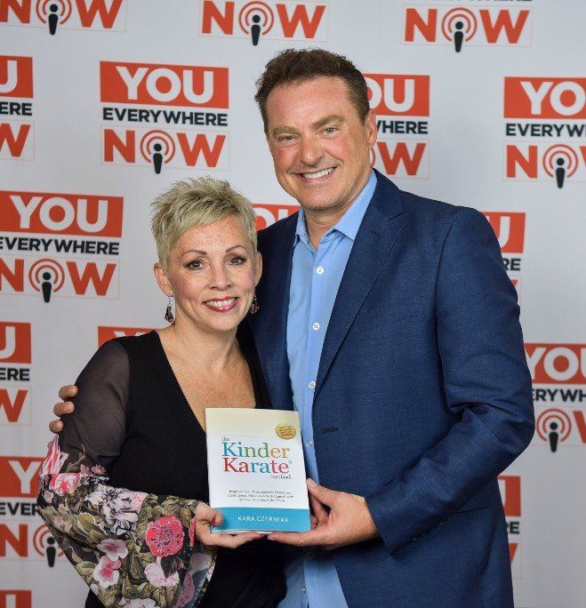 Kara Czerniak with Mike Koenigs, CEO of You Everywhere Now, celebrating her international bestseller 