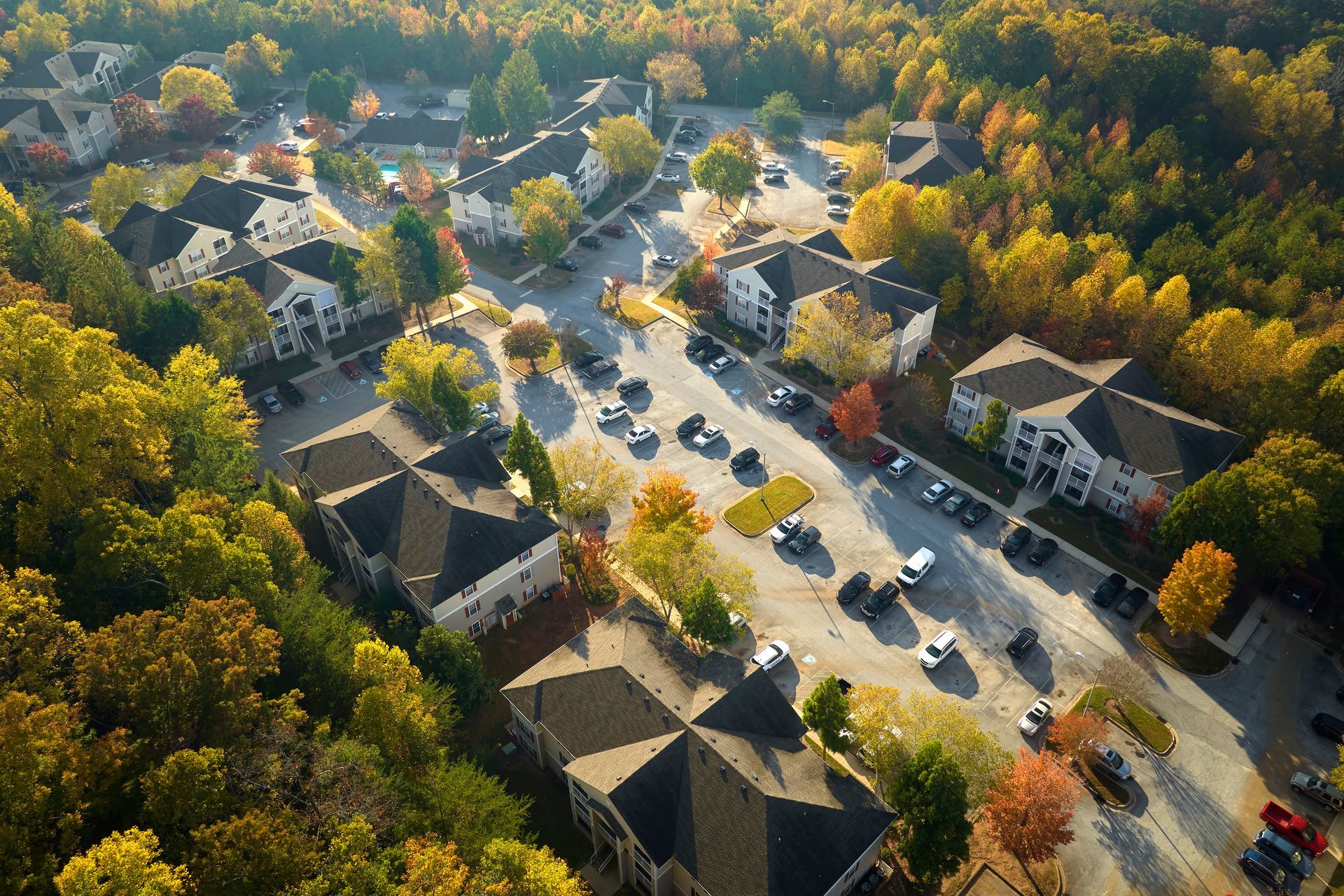 view from above of apartment complex surrounded by healthy trees