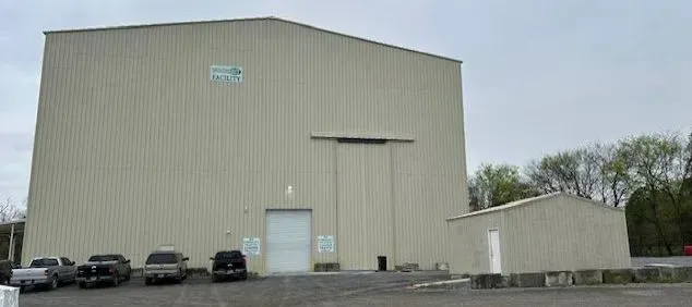 A large building with a lot of cars parked in front of it.