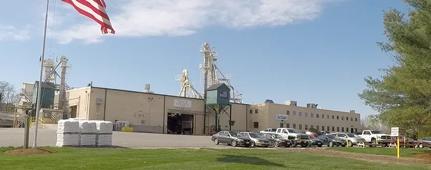 An american flag is flying in front of the hatfield manufacturing facility