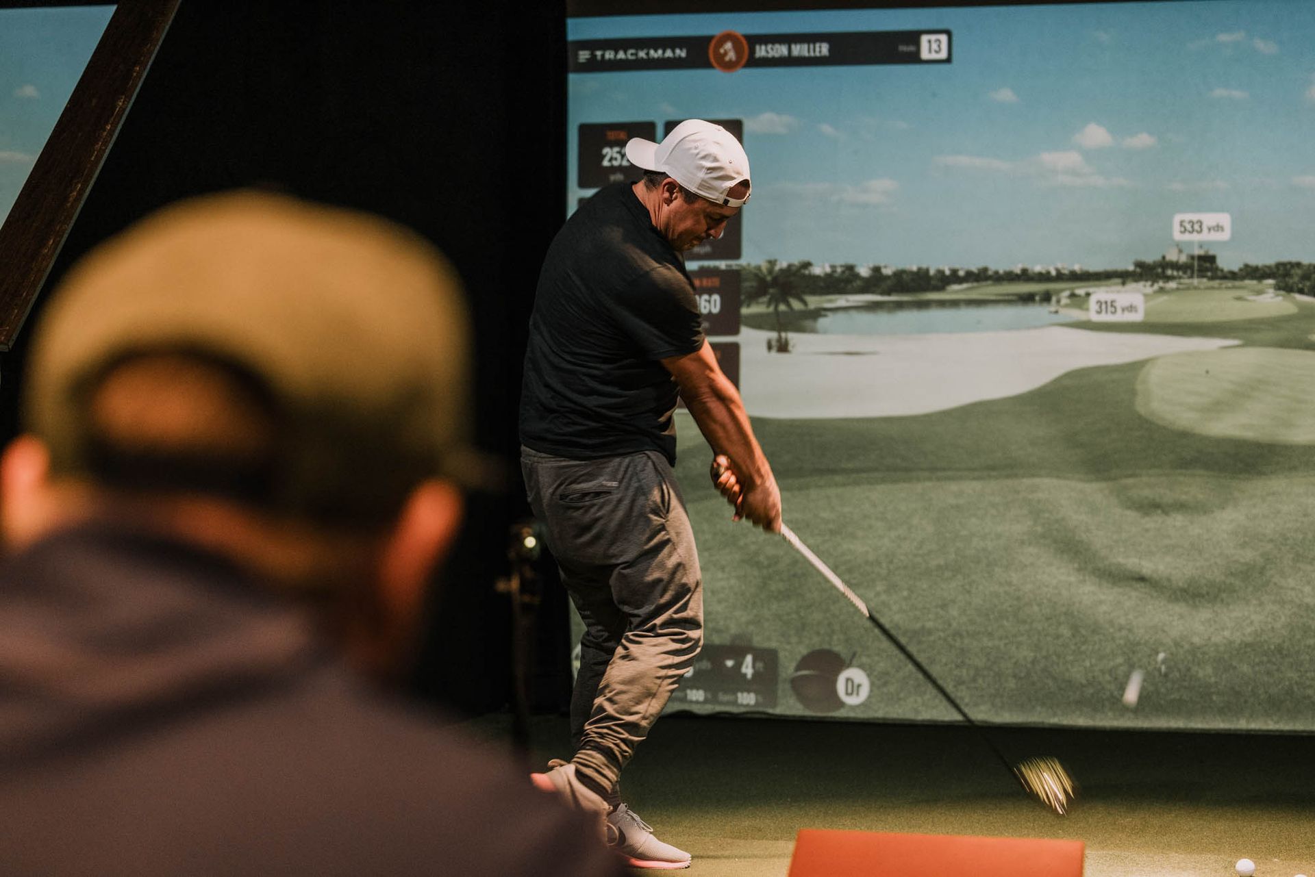 simulator bay with golfer