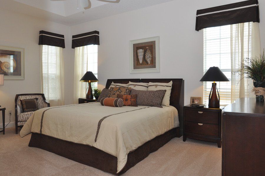 A bedroom with a large bed and a dresser