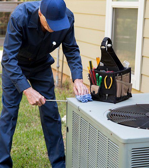 Technician Repairing HVAC Unit | Stephenville, TX | Alderfer's Air Conditioning & Refrigeration Service Inc