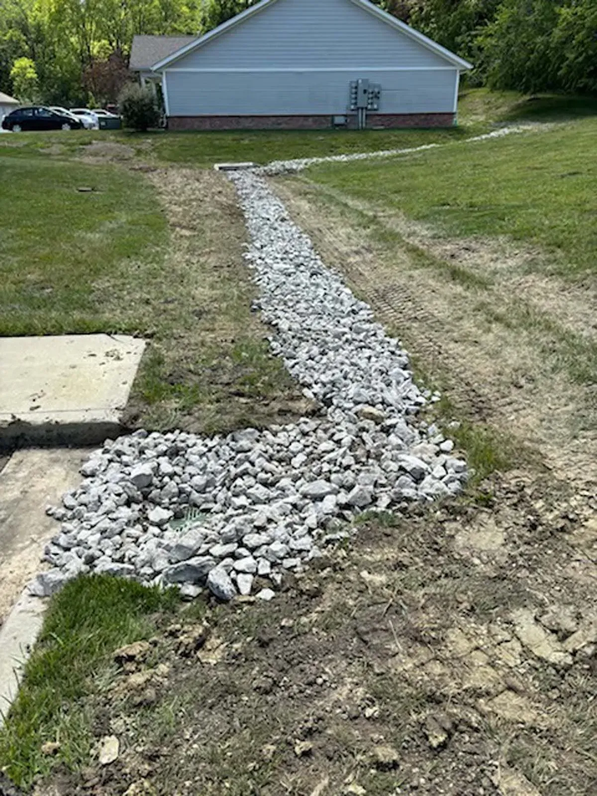 A gravel path is being built in front of a house.