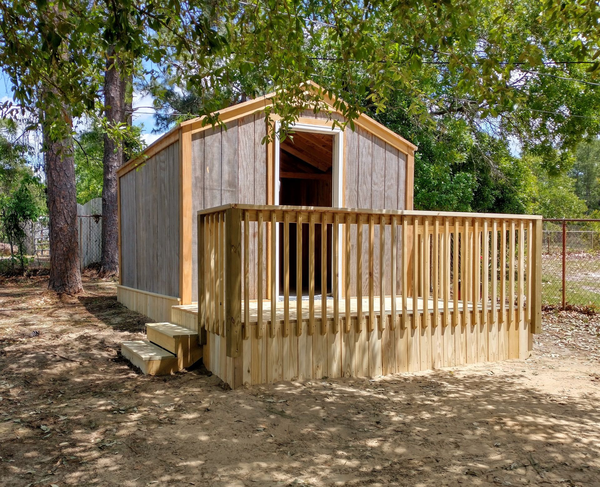 A small house with a wooden deck and stairs