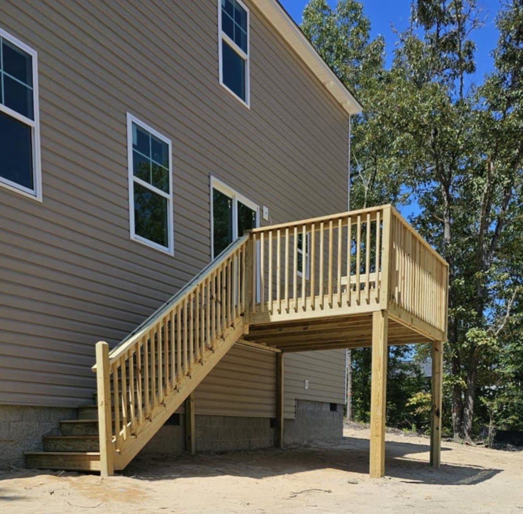 A house with a wooden deck and stairs leading up to it