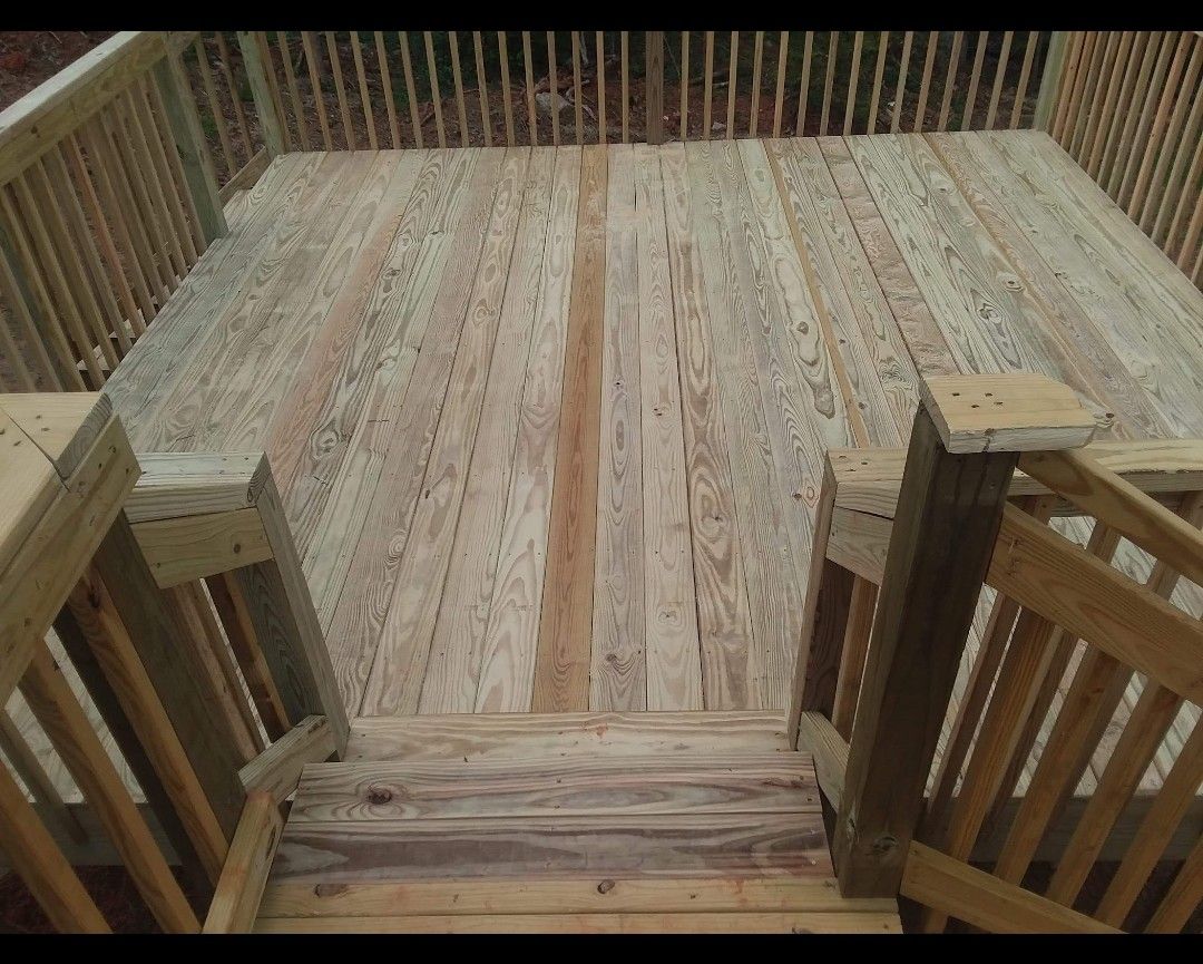 A wooden deck with stairs leading up to it