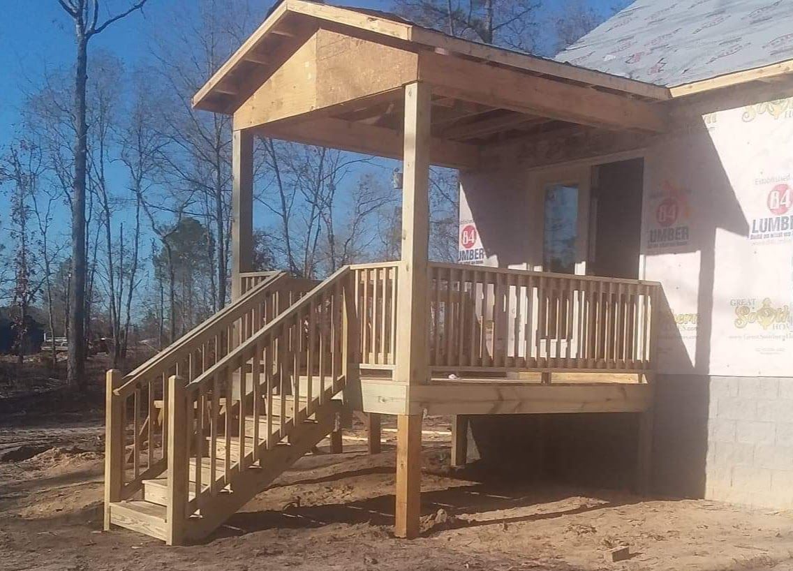 A wooden porch with stairs leading up to it