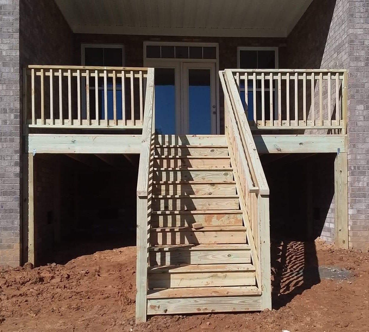 A wooden deck with stairs leading up to it