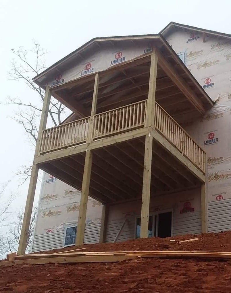 A house under construction with a wooden deck on top of it