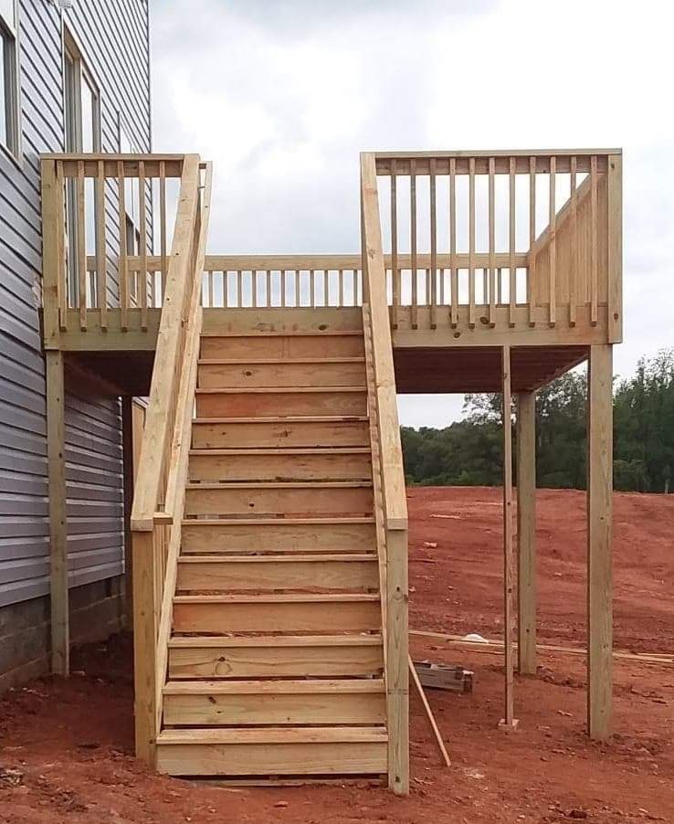 A wooden deck with stairs leading up to it