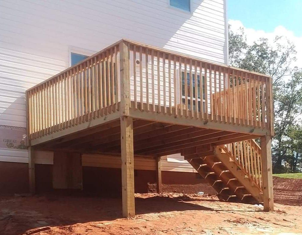 A wooden deck with stairs leading up to it