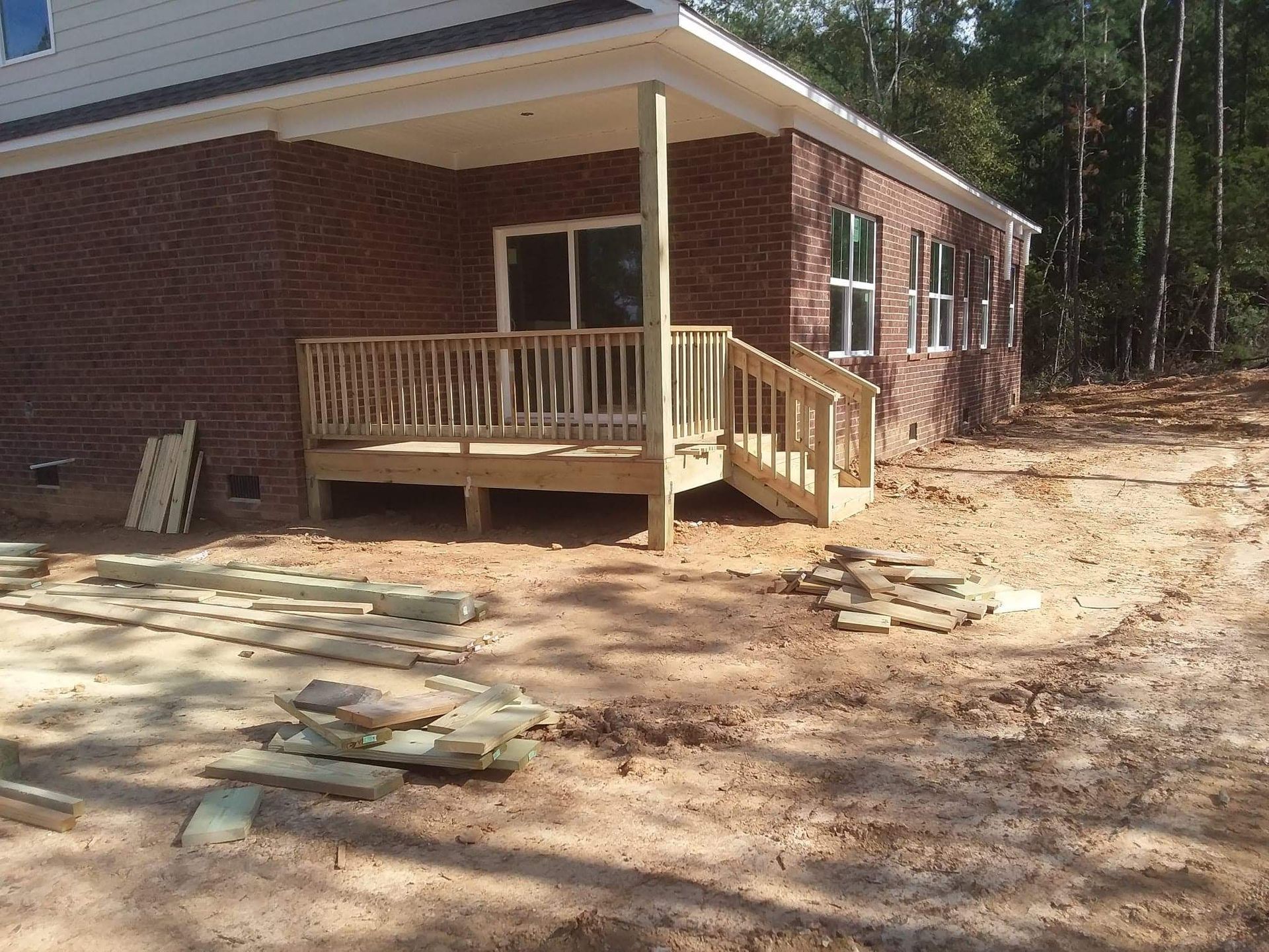 A brick house with a wooden deck in front of it
