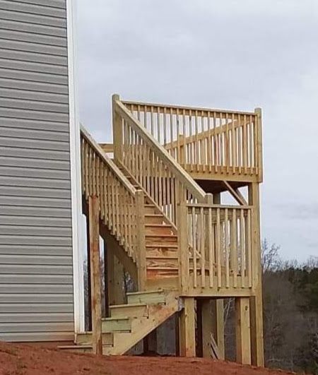 A wooden deck with stairs leading up to it