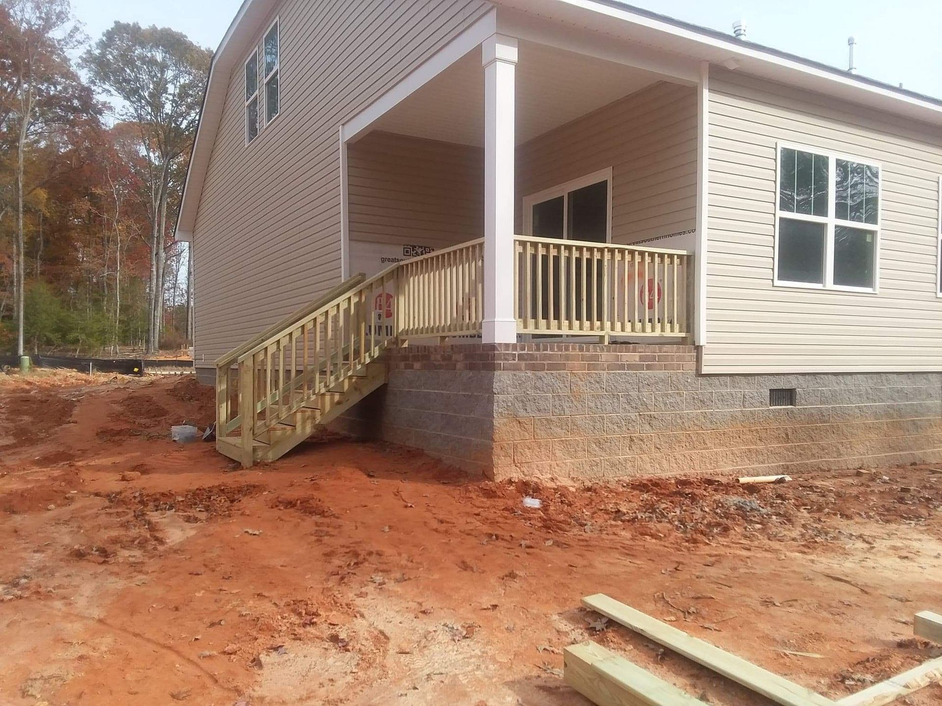 A house under construction with a deck and stairs